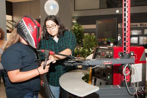 Open House visitor uses a virtual welding torch