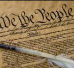 Photo of the Constitution of the United States of America and a feather quill