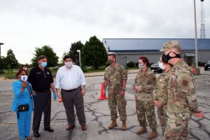 Dr. Lynette D. Stokes, South Suburban College President; JB Pritzker; Illinois Governor; Frank M. Zuccarelli, Chairman of the SSC Board of Trustees; and members of the National Guard discuss the opening of the new COVID-19 testing facility