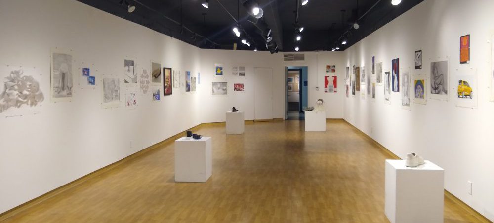 Photo of some of the art in the Thiel Gallery during the Bi-Annual Student Art Show