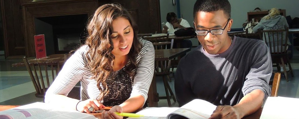 A photo of a student being tutored at the Reading Center