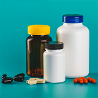 Three pill bottles and various pills