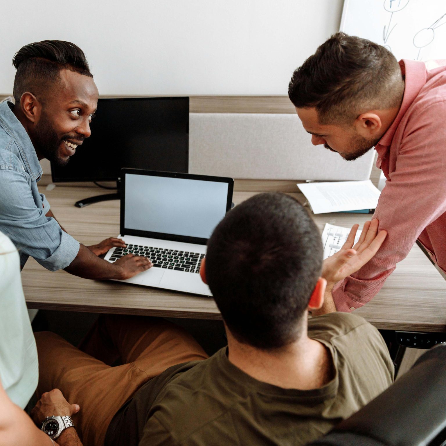 Students work together on laptop.
