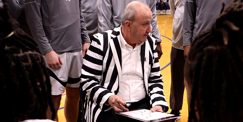 Action shot during a 2025 men's basketball game.