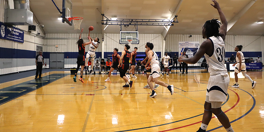 Action shot during a 2025 men's basketball game.