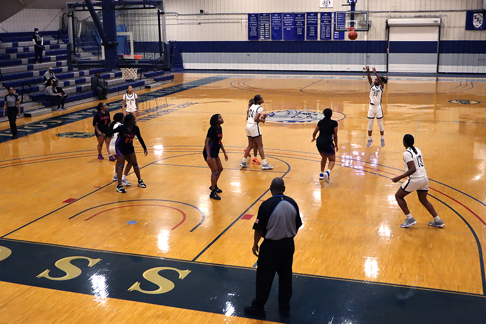 Action shot during a 2025 women's basketball game.