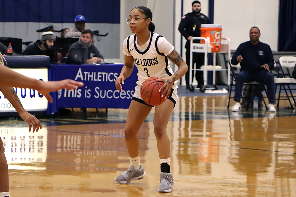 Action shot during a 2025 women's basketball game.