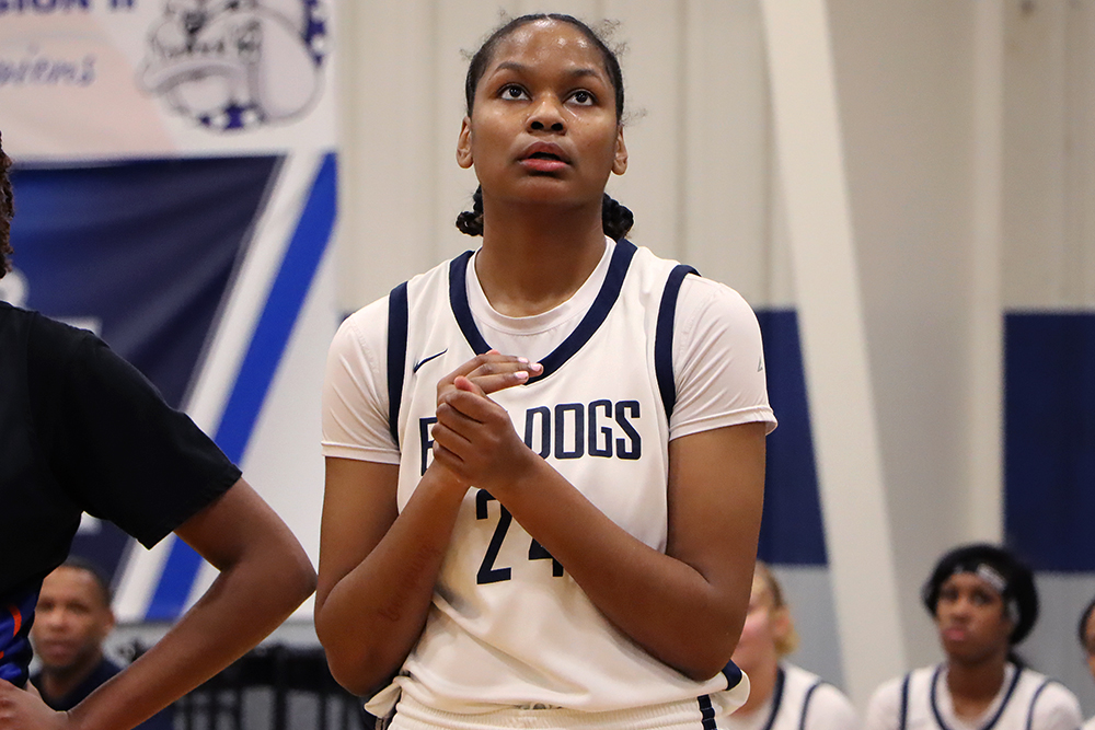 Action shot during a 2025 women's basketball game.