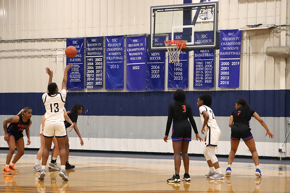 Action shot during a 2025 women's basketball game.