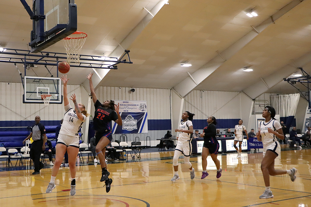 Action shot during a 2025 women's basketball game.