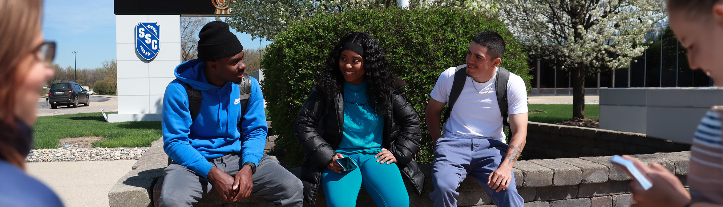 Happy Students Talk Outside of Main Campus